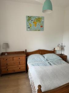 a bedroom with a bed and a map on the wall at Pelini - 2 in Szentendre