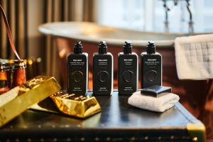 a table with four shampoo bottles on a table at Hotel Gotham in Manchester