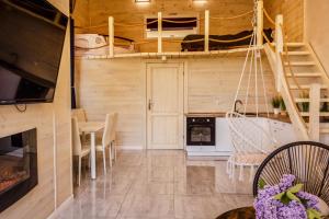 a kitchen and dining room with a staircase in a tiny house at Apartament Plus in Mrągowo
