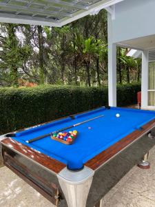 a pool table sitting on top of a patio at Villa Nesa in Cipanas