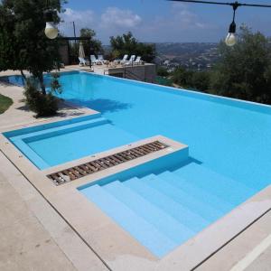 a large blue swimming pool with a drain in it at Abdelli Terraces in Batroun in Batroûn