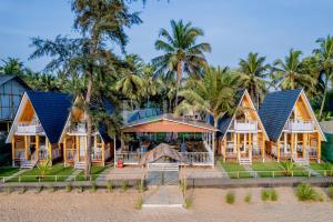 a resort on the beach with palm trees at Agonda Palm Beach Resort in Agonda