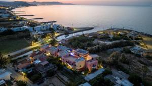 an aerial view of a house by the water at night at Kri-Kri Village Holiday Apts by Estia in Kokkini Khanion