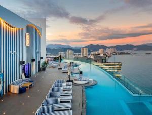 a pool on the top of a building with a view of the water at Panorama Nha Trang Sky Beach in Nha Trang