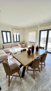 a large living room with a wooden table and chairs at Moutzouri Villes in Thános +14 photos