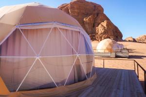 a dome tent in the desert with two domes at Mirage Camp Wadi Rum in Wadi Rum