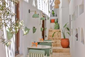a room with a table and chairs and stairs at Old Town Hotel Kalkan in Kalkan