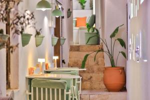 a room with two tables and potted plants at Old Town Hotel Kalkan in Kalkan