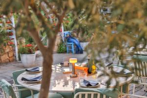 a table with plates and napkins on top at Old Town Hotel Kalkan in Kalkan