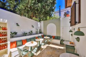 a patio with tables and chairs in a restaurant at Old Town Hotel Kalkan in Kalkan
