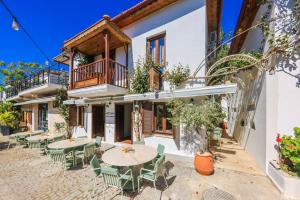 an outdoor patio with tables and chairs in front of a building at Old Town Hotel Kalkan in Kalkan