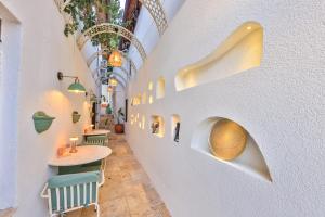 a corridor of a restaurant with a table and chairs at Old Town Hotel Kalkan in Kalkan