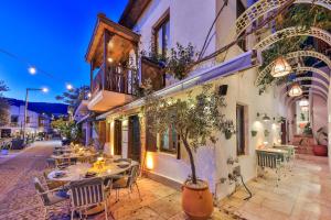 a restaurant with tables and chairs on a street at Old Town Hotel Kalkan in Kalkan