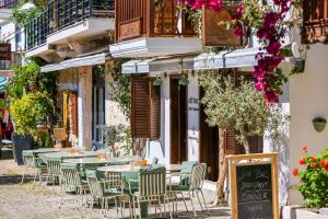 an outdoor cafe with tables and chairs on a street at Old Town Hotel Kalkan in Kalkan