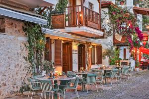 an outdoor restaurant with tables and chairs on a street at Old Town Hotel Kalkan in Kalkan