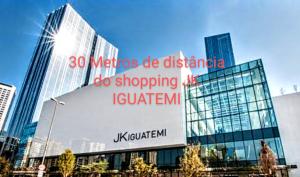 a large building with a sign on the side of it at Hotel M-RCURE JK - Itaim BiBi - Urban Duplex Deluxe Studio - First Class - Collors Edition - By Hous enn in Sao Paulo