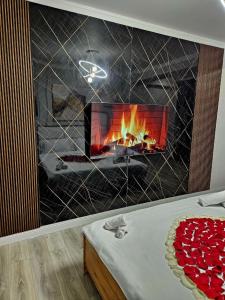 a living room with a fireplace and a tv at PERFECT APARTMENTS in Almaty