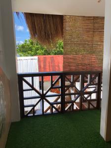 a wooden gate in a room with green grass at Maligaya Maison in General Luna