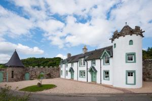 a large white building with a tower at Dryburgh Stirling Two in Saint Boswells