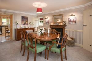 a kitchen and dining room with a table and chairs at Dryburgh Stirling One in Saint Boswells