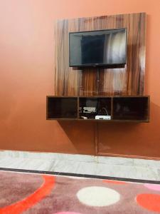a flat screen tv on a wall at Sunrise guesthoues in Greater Noida