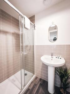 a bathroom with a sink and a shower at Templer Mill by Solace Stays 2 Shower Rooms in Newport