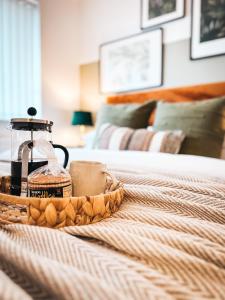 a bed with a tray of food on it at Templer Mill by Solace Stays 2 Shower Rooms in Newport