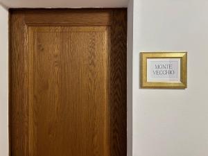 a wooden door with a sign next to it at Locanda Corte Ruspecchio in Quattro Castella