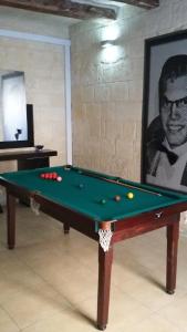 a pool table with balls on it in a room at House Valletta in Valletta