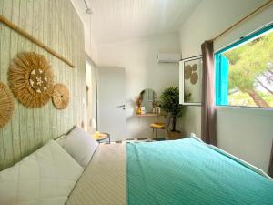 a bedroom with a bed and a window at Peaceful Cottage House By The Sea - Private Garden in Análipsis