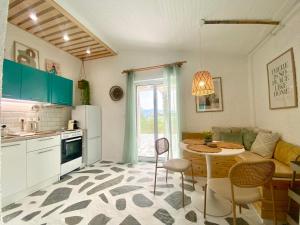 a kitchen and living room with a table and chairs at Peaceful Cottage House By The Sea - Private Garden in Análipsis