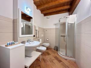 a bathroom with a sink toilet and a shower at Locanda Corte Ruspecchio in Quattro Castella