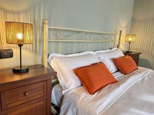 a bedroom with a bed with two pillows on it at Locanda Corte Ruspecchio in Quattro Castella