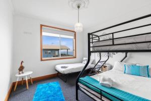 A bed or beds in a room at Absolute Bay Frontage with Open Fire and Spa Bath