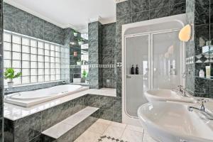 A bathroom at Absolute Bay Frontage with Open Fire and Spa Bath