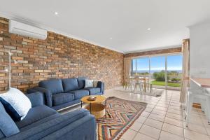 A seating area at Absolute Bay Frontage with Open Fire and Spa Bath