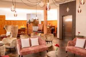 a living room with chairs and a table at Hotel Krone Langenegg in Langenegg