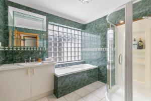 A bathroom at Absolute Bay Frontage with Open Fire and Spa Bath
