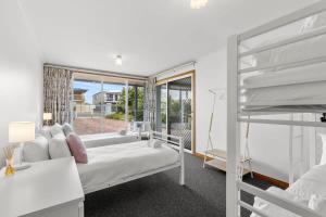 A bed or beds in a room at Absolute Bay Frontage with Open Fire and Spa Bath