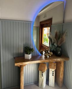 a room with a wooden table with a mirror at Via Ferrata Hotel in Prousós