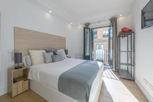 a bedroom with a large bed and a large window at Gran Via NEW 2BR 1BT Elevator in Madrid
