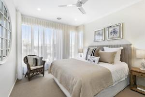 a bedroom with a bed and a chair and a window at Hampton's Getaway in Torquay in Torquay
