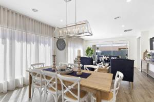 a dining room and living room with a table and chairs at Hampton's Getaway in Torquay in Torquay