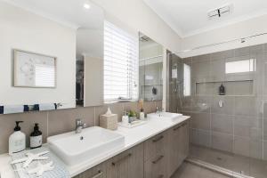 a white bathroom with two sinks and a shower at Hampton's Getaway in Torquay in Torquay +16 photos