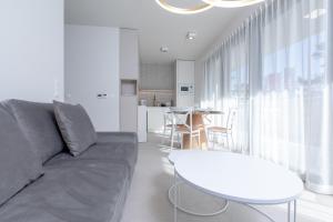a living room with a couch and a table at HEVENIA POGORZELICA - APARTAMENT 2 in Pogorzelica