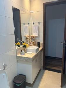 a bathroom with a sink and a mirror at Casa na praia em frente as Dunas in Salvador