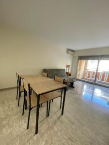 a living room with a table and a couch at GuestRoom - Chambre d'hôte in Le Cannet