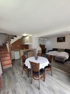a kitchen and a living room with a table and chairs at D&D Busteni in Buşteni