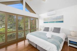a bedroom with a large bed and large windows at Happy Place of Light and Water Views in Jan Juc in Torquay +15 photos
