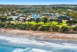 an aerial view of a beach with a resort at Whitewash Beachfront Apartment on The Esplanade in Torquay +11 photos